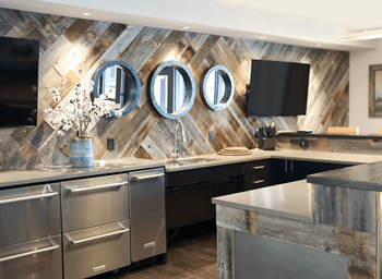 A modern kitchen with a wooden backsplash and stainless steel appliances.